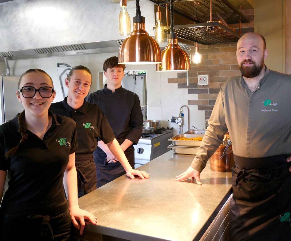 L'équipe du Ginko devant la cuisine ouverte du restaurant
